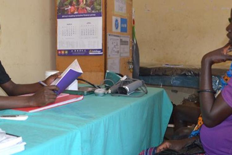 Caroline Akello attending to a mother at Loktelabu Health Centre III